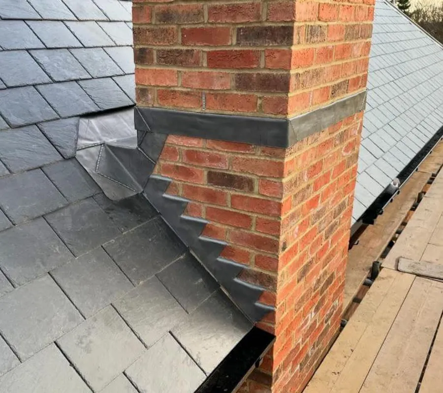 Lead flashing around a brick chimney