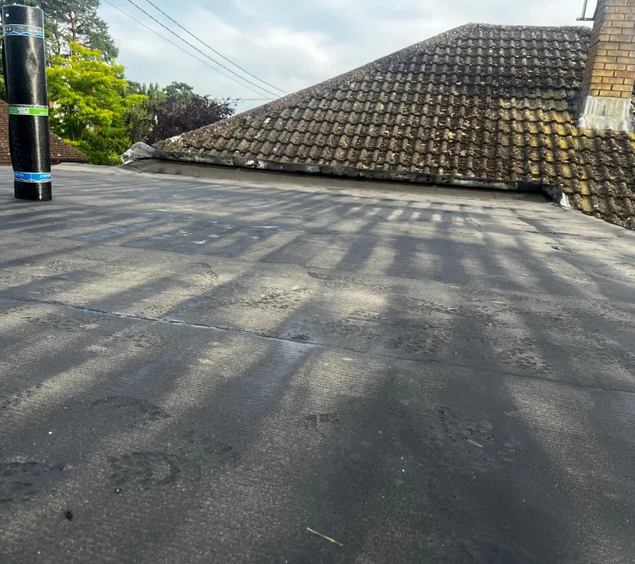 A finished flat roof below a tiled roof