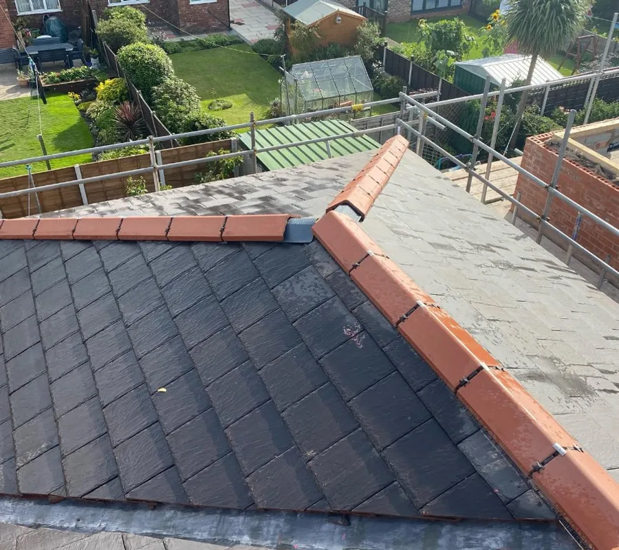 A new slate roof with a red tiled ridge